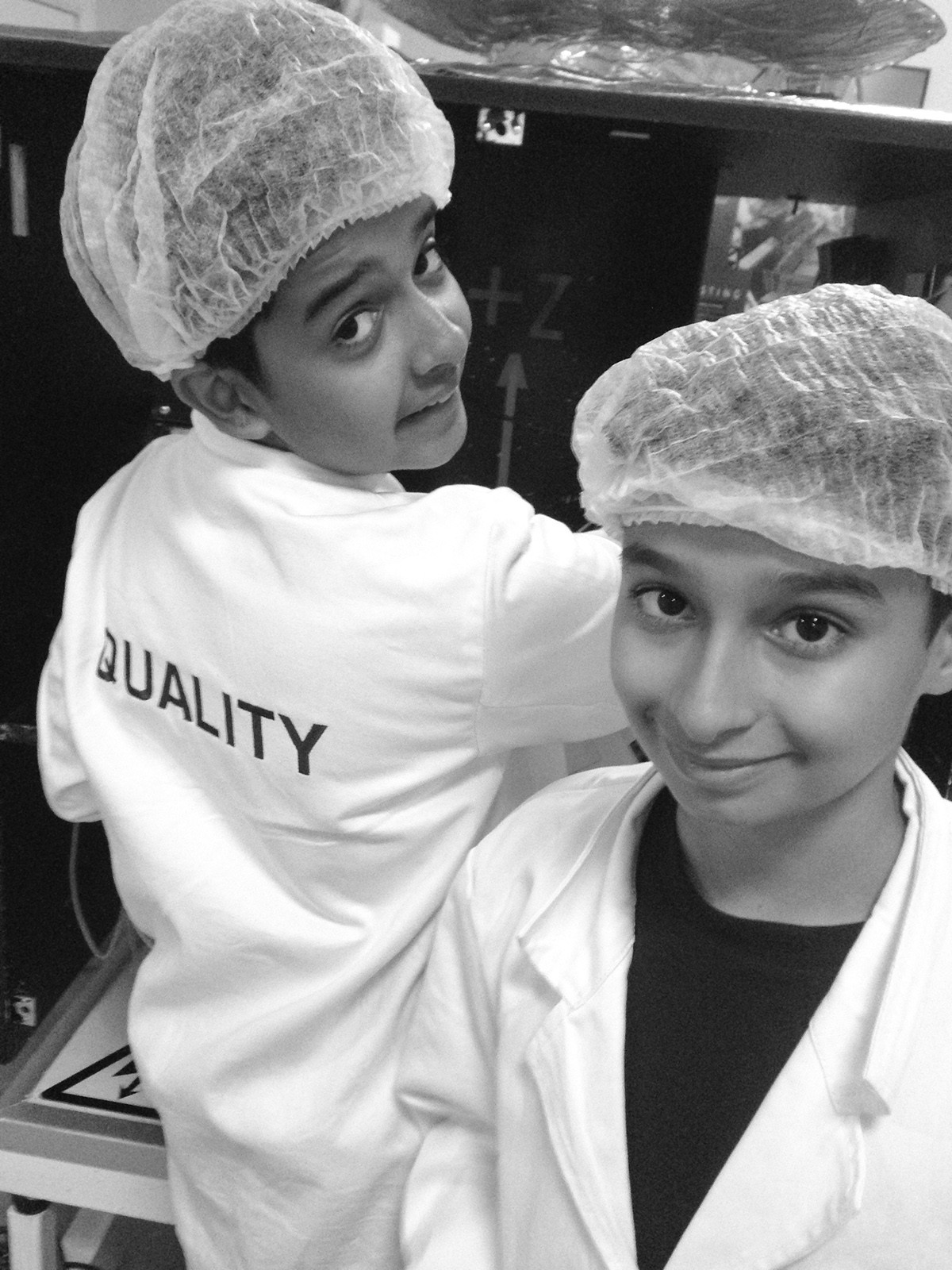 STARS CAMP student in a satellite clean room, hairnet and lab coat